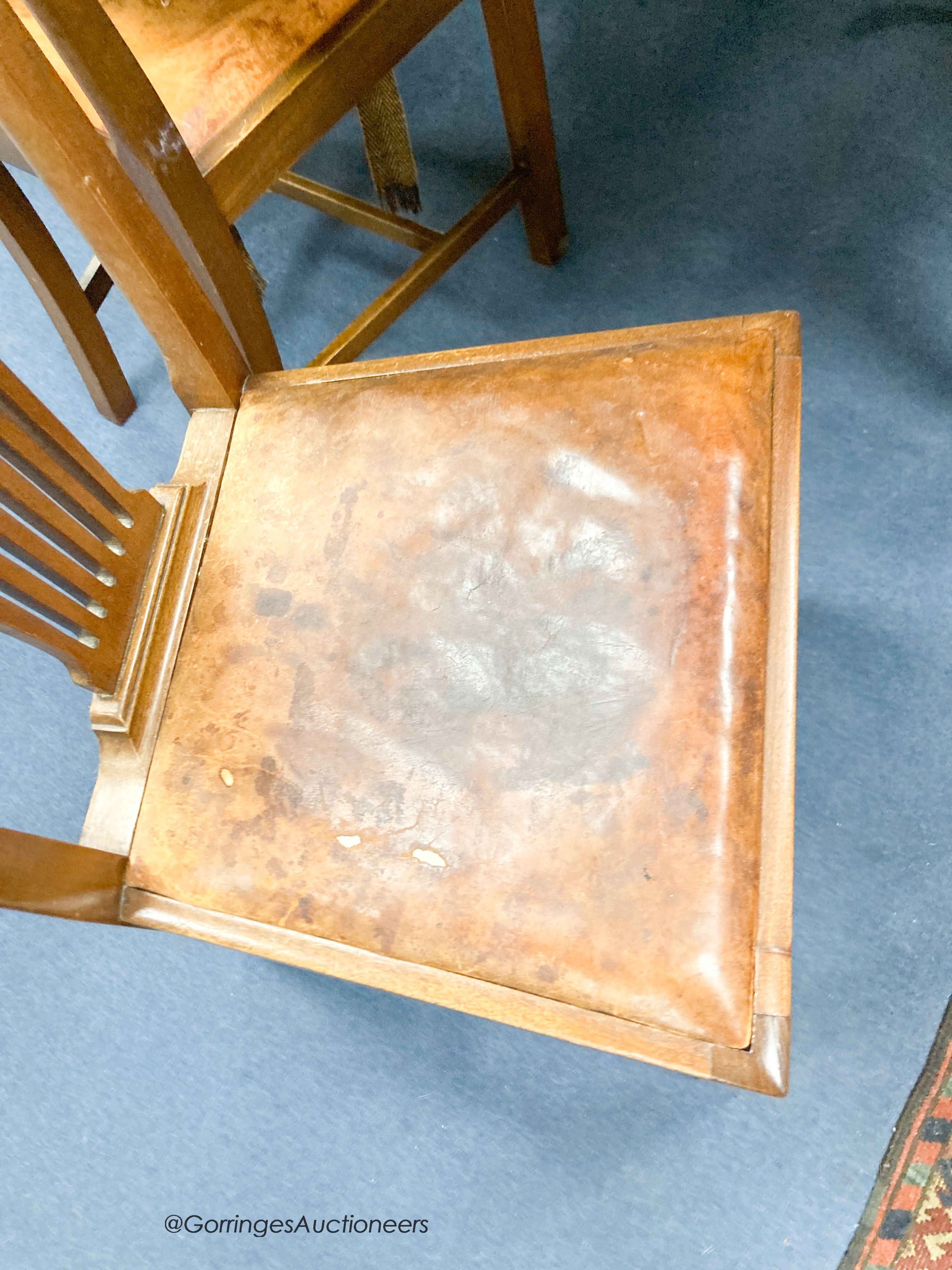 An Edwardian mahogany oval extending dining table, length 180cm extended with one spare leaf, width 120cm, height 74cm together with four George III style mahogany dining chairs